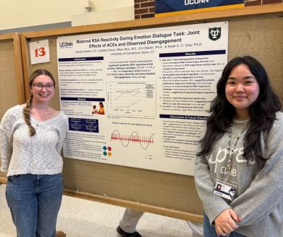 Undergrad RA Bella and graduate student Claudia presenting their poster at the Spooktacular Poster Night