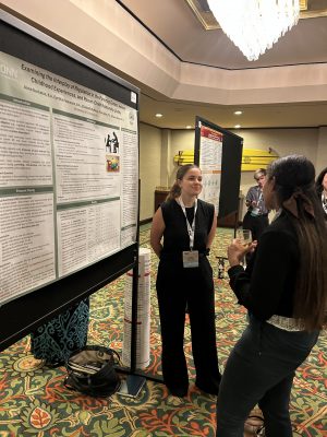 Graduate student Anna presenting her poster at ISDP.